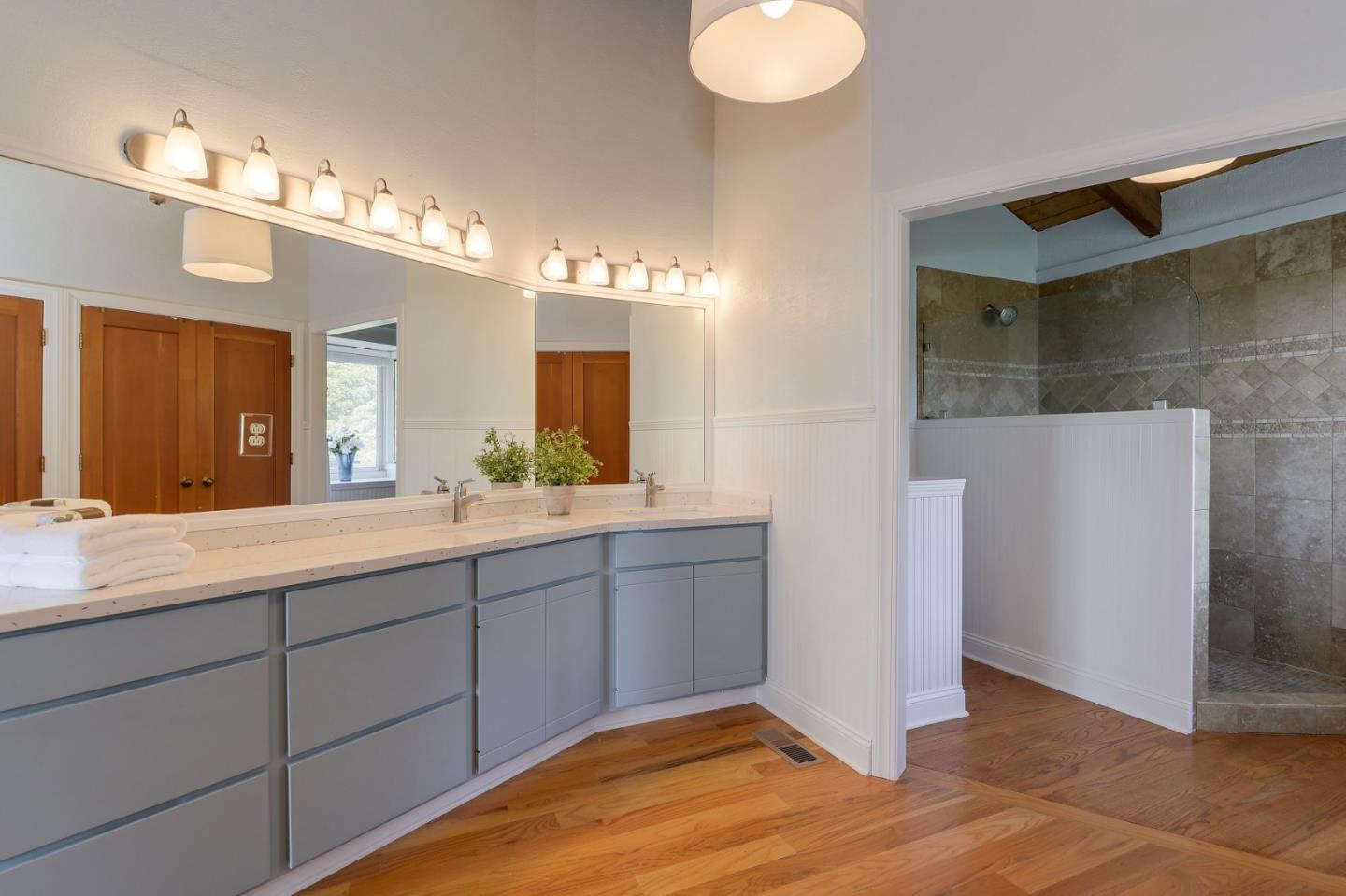 18503 Favre Ridge Road Los Gatos, CA 95033 - Photo 27 of 40 a bathroom with a double vanity sink and a mirror