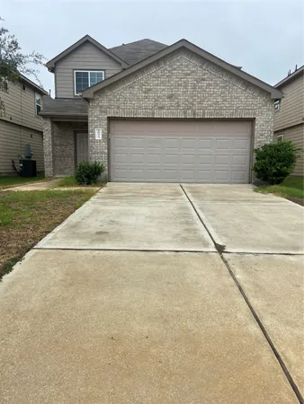 a front view of a house with a garden and plants