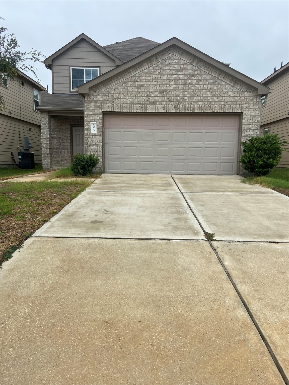 a front view of a house with a garden and plants