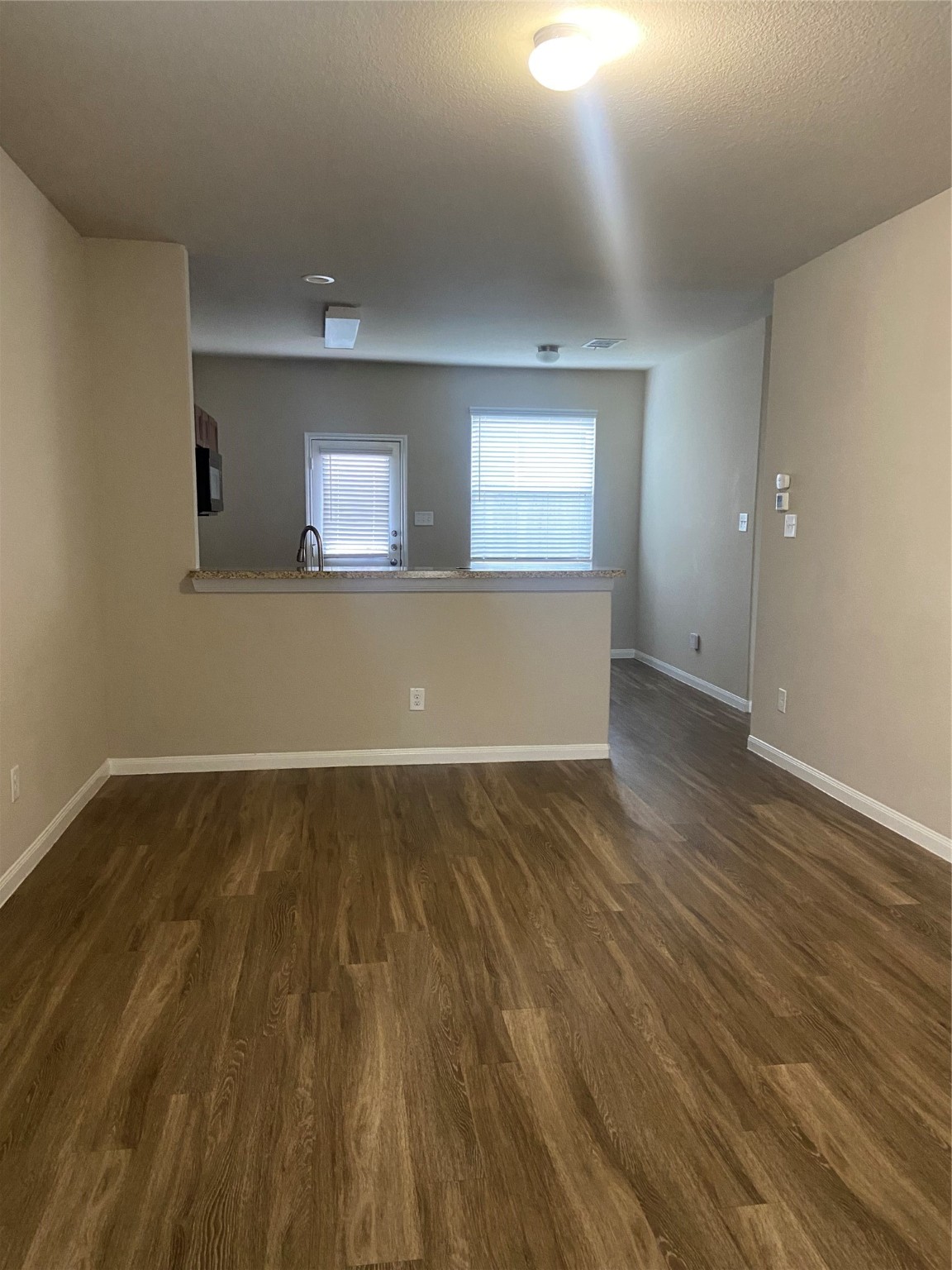 18614 Cooper Ravine Way Katy, TX 77449 - Photo 4 of 9 wooden floor in an empty room with a window