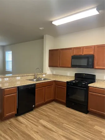 a kitchen with stainless steel appliances granite countertop a stove and a sink