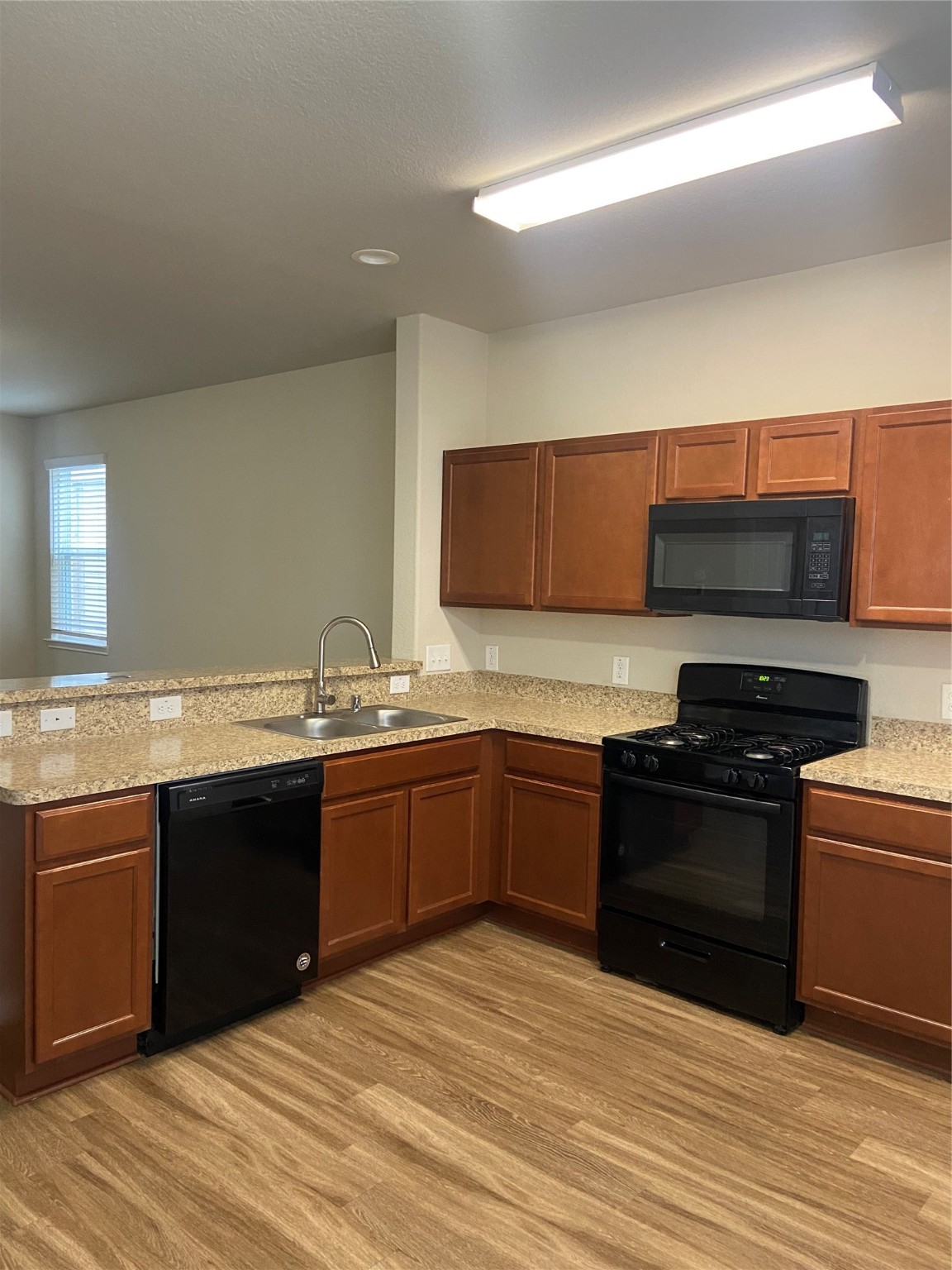 18614 Cooper Ravine Way Katy, TX 77449 - Photo 6 of 9 a kitchen with stainless steel appliances granite countertop a stove and a sink