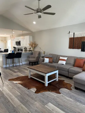 a living room with furniture and wooden floor