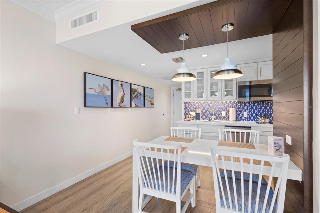 240 Sands Point Road, Unit 4104 Longboat Key, FL 34228 - Photo 12 of 47 a view of a dining room with furniture and chandelier