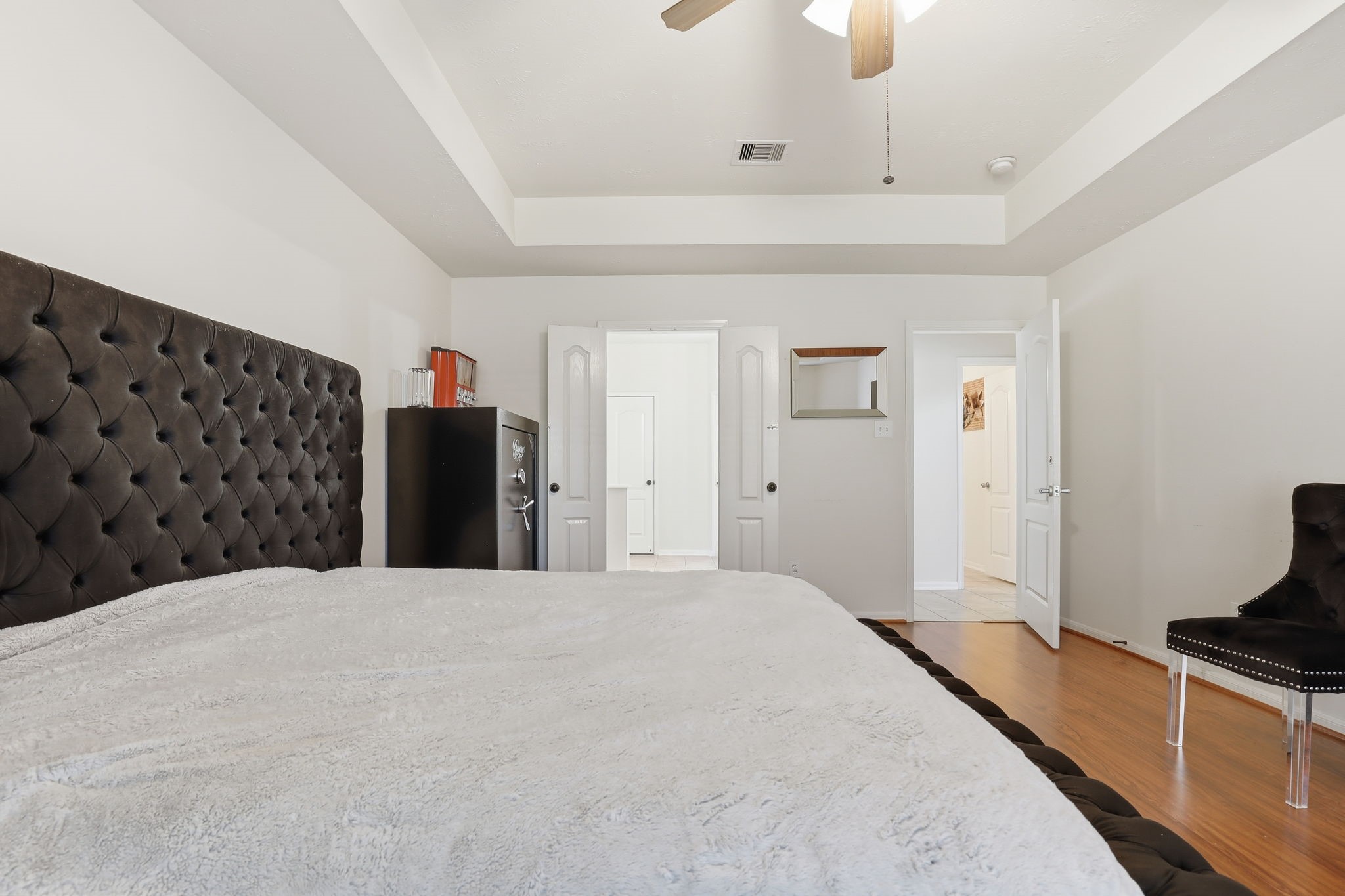30615 Winlock Trails Drive Spring, TX 77386 - Photo 14 of 33 a bedroom with a bed and a black countertop with white walls