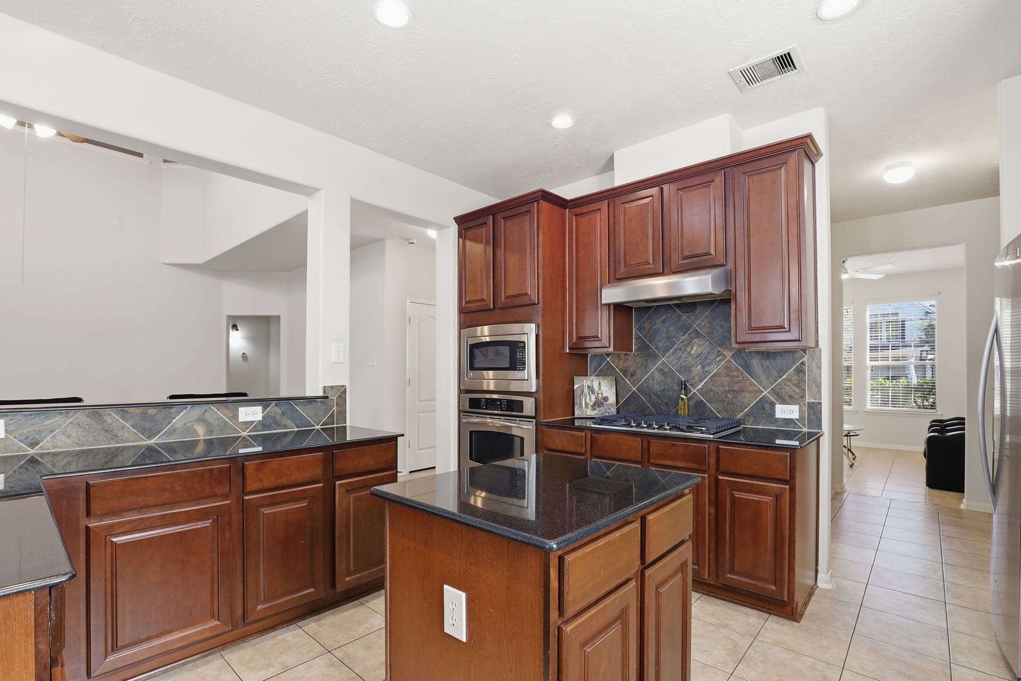 30615 Winlock Trails Drive Spring, TX 77386 - Photo 5 of 33 a kitchen with kitchen island granite countertop a sink and cabinets