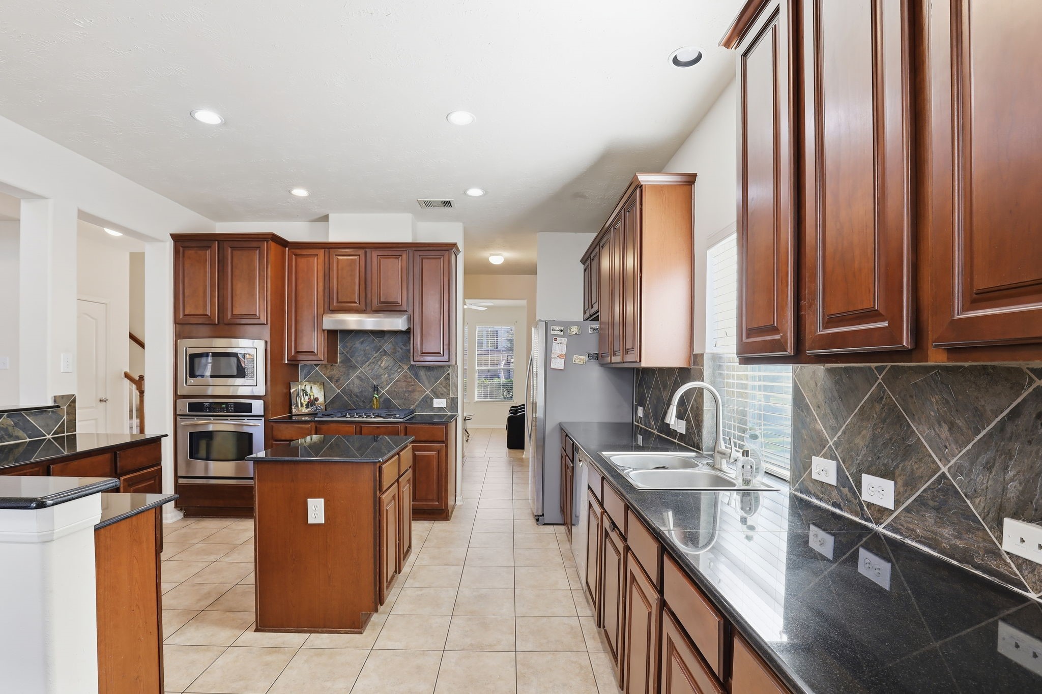 30615 Winlock Trails Drive Spring, TX 77386 - Photo 6 of 33 a kitchen with stainless steel appliances granite countertop a sink stove and refrigerator