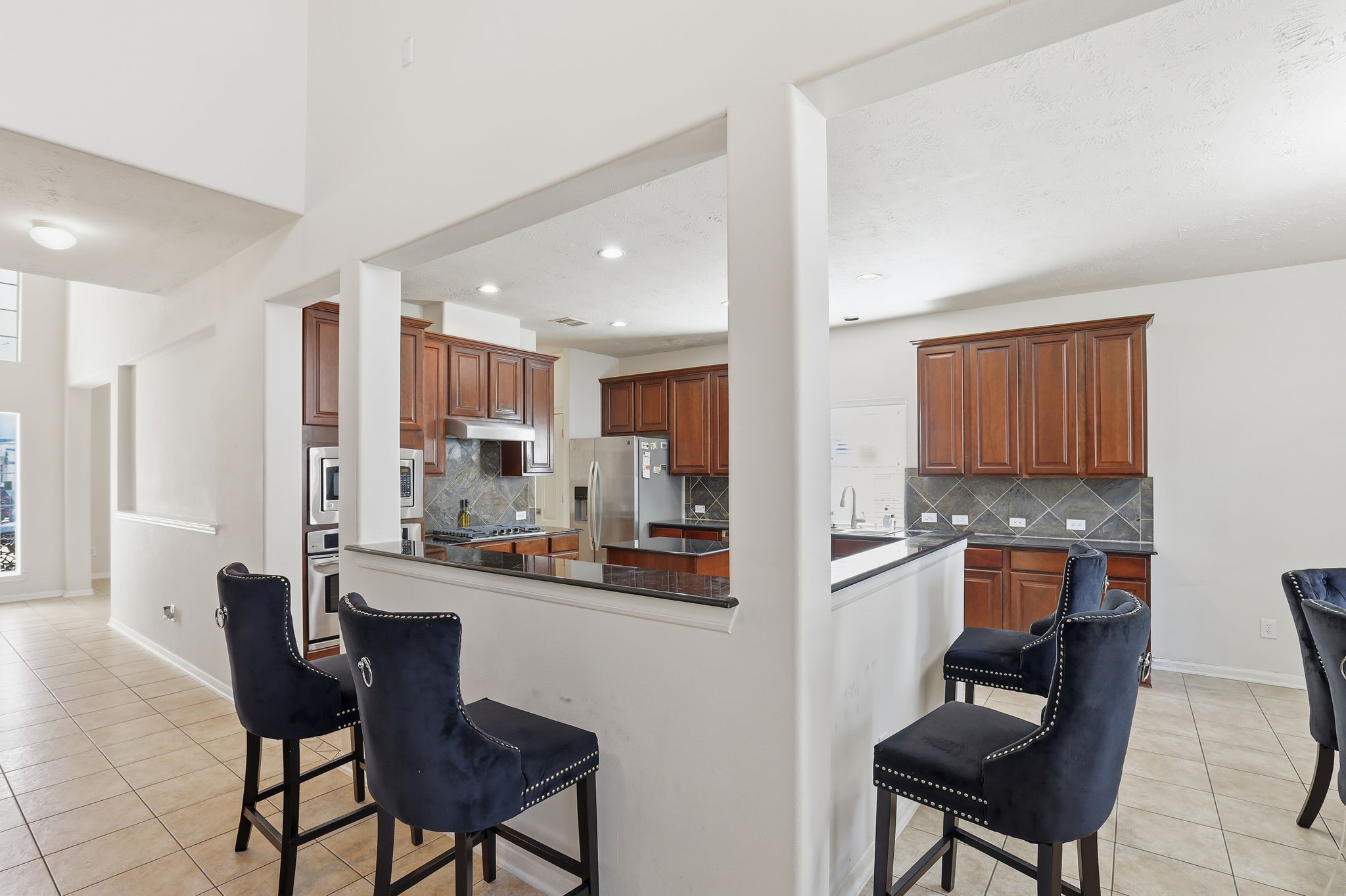 30615 Winlock Trails Drive Spring, TX 77386 - Photo 8 of 33 a kitchen with a dining table chairs and a refrigerator