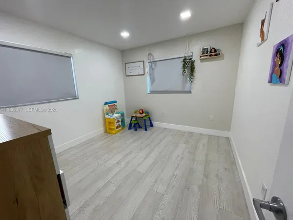 a room with wooden floor and furniture
