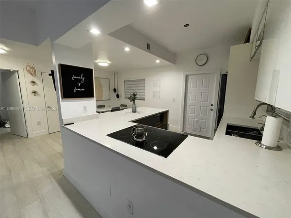 a kitchen with stainless steel appliances a refrigerator a sink a stove a microwave a counter top and oven
