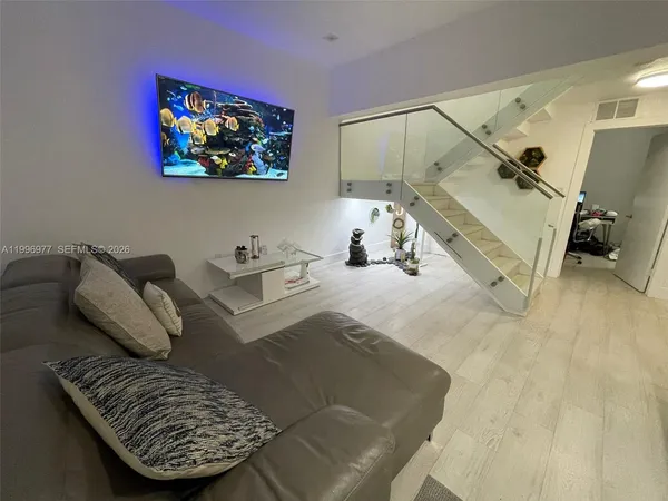 a living room with furniture and a flat screen tv