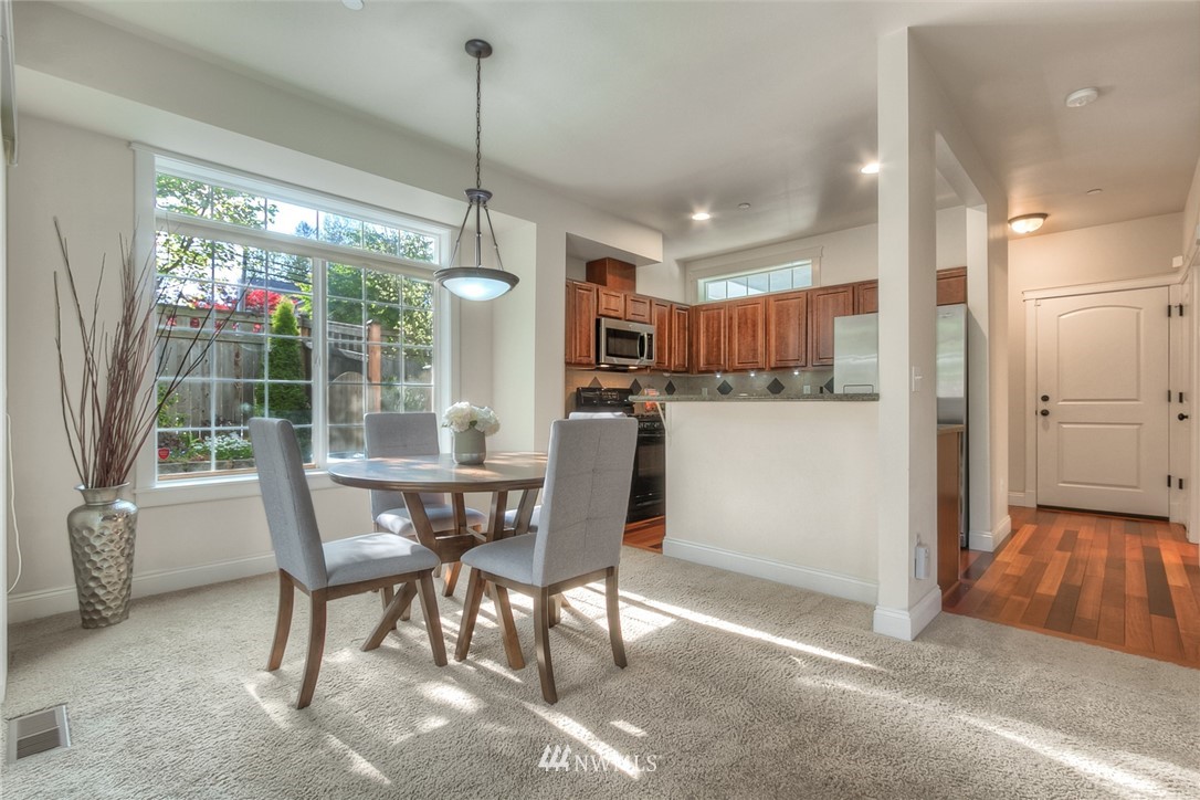 902 225th Place Southeast Bothell, WA 98021 - Photo 11 of 20 a view of a dining room with furniture large windows and wooden floor