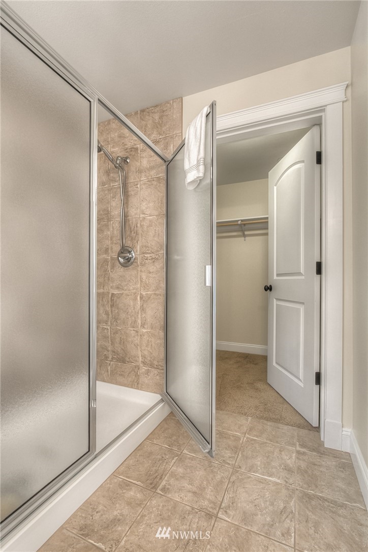 902 225th Place Southeast Bothell, WA 98021 - Photo 18 of 20 a bathroom with a glass shower door