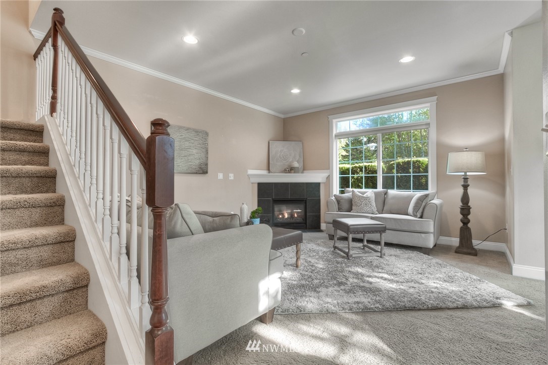902 225th Place Southeast Bothell, WA 98021 - Photo 7 of 20 a living room with furniture and a fireplace