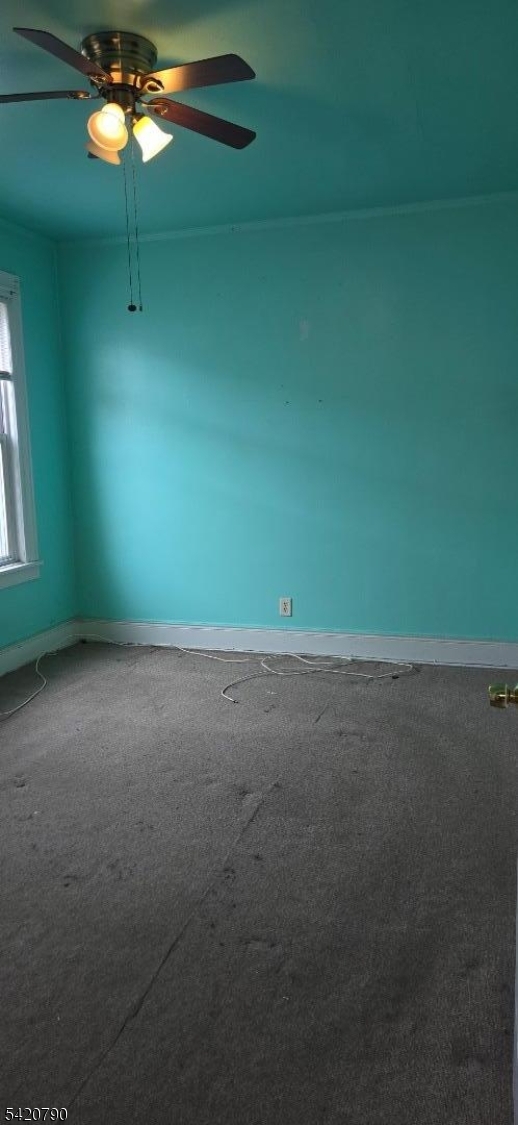 449 East 26th Street Paterson, NJ 07514 - Photo 3 of 9 a view of a room with window and ceiling fan