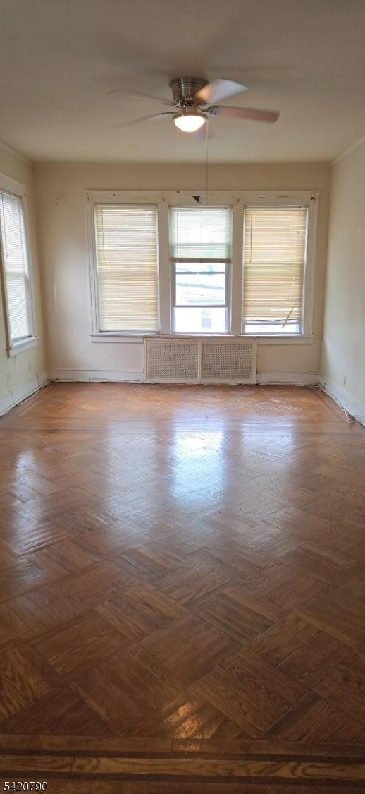 449 East 26th Street Paterson, NJ 07514 - Photo 5 of 9 an empty room with wooden floor and windows