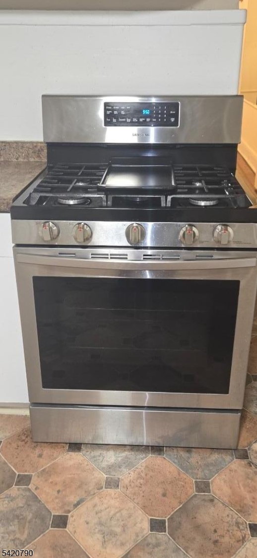 449 East 26th Street Paterson, NJ 07514 - Photo 8 of 9 a stove top oven sitting inside of a kitchen