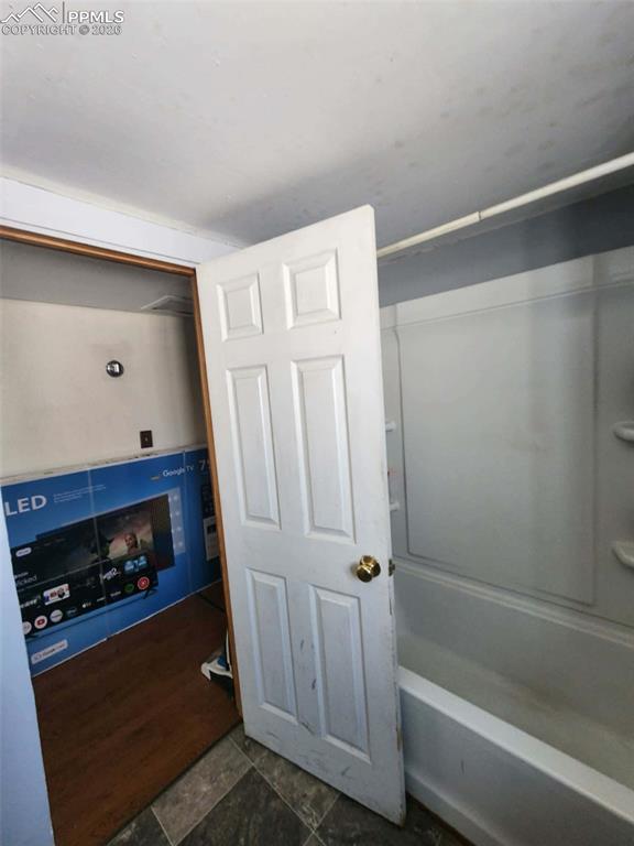 24405 Handle Road Calhan, CO 80808 - Photo 20 of 30 a bathroom with a tub and a wooden floor