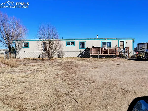 a view of a house with a car parked in front of it