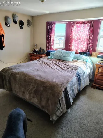 a bedroom with a bed and window