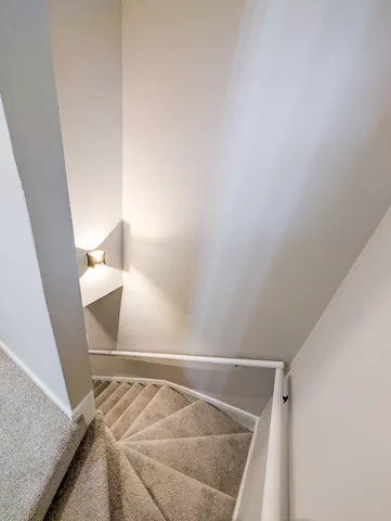 a view of staircase with white walls