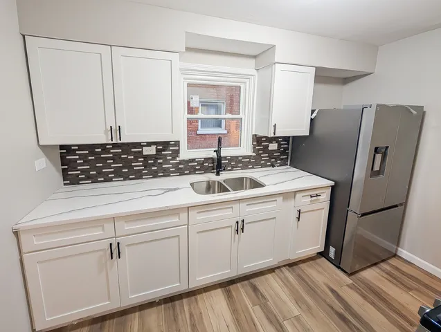a kitchen with stainless steel appliances a refrigerator and cabinets