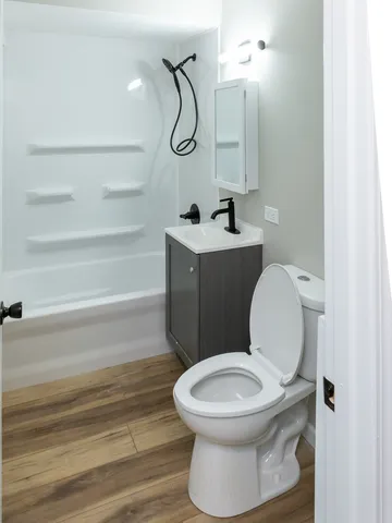 a white toilet sitting next to a bathroom sink