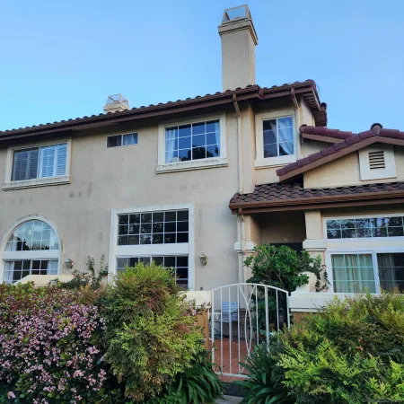 a view of a house with brick walls and potted plants