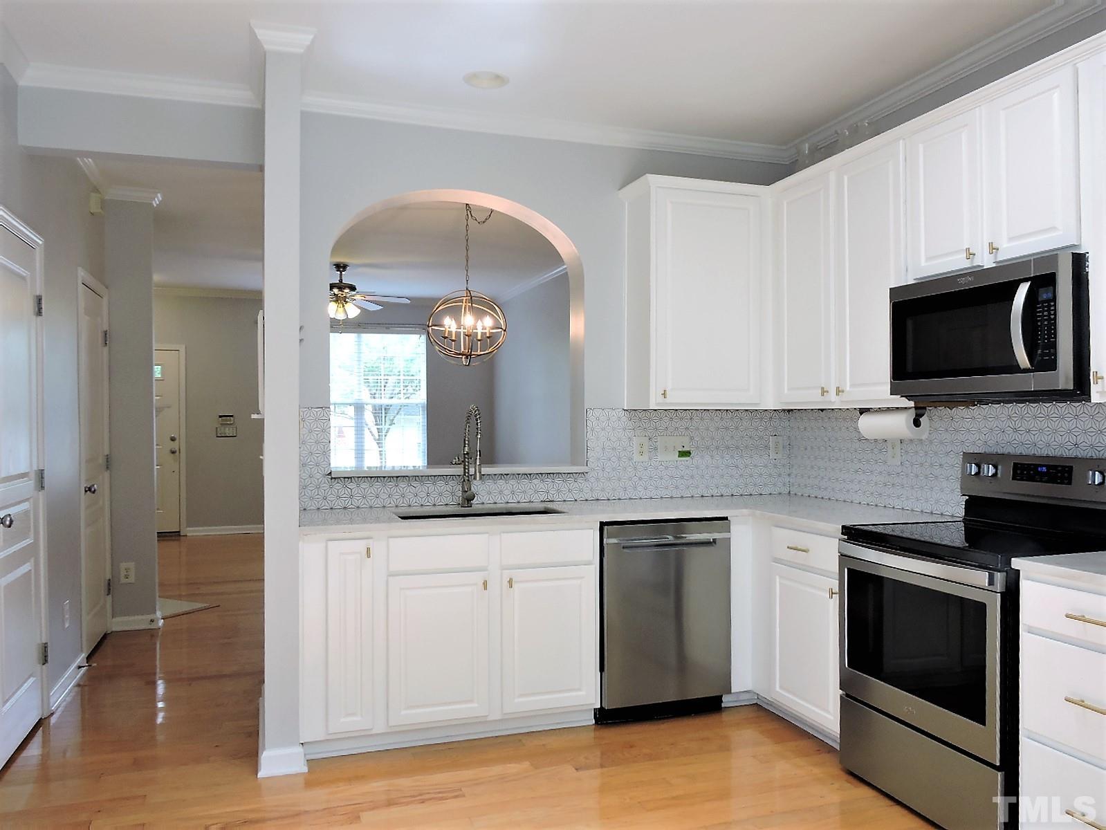 3811 Ramblewood Avenue Durham, NC 27713 - Photo 20 of 29 a kitchen with granite countertop a sink and stainless steel appliances