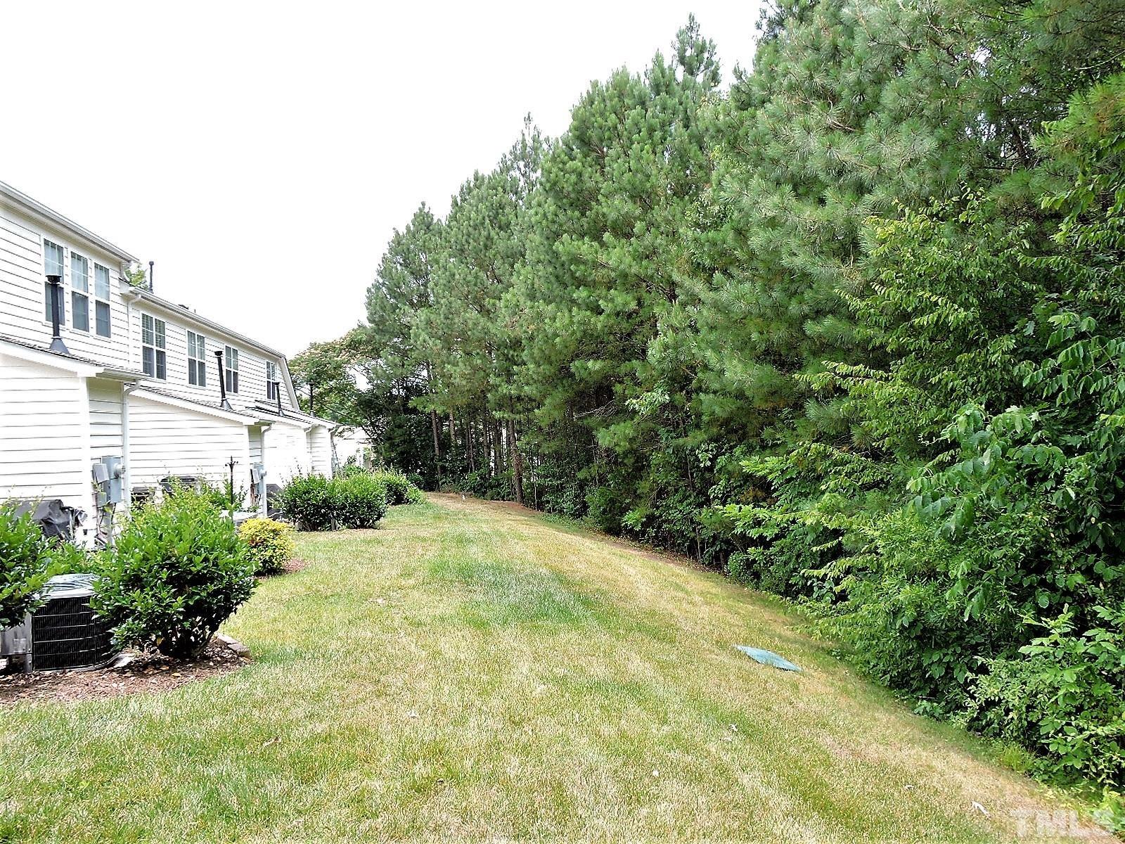 3811 Ramblewood Avenue Durham, NC 27713 - Photo 26 of 29 a view of a yard with plants and large trees