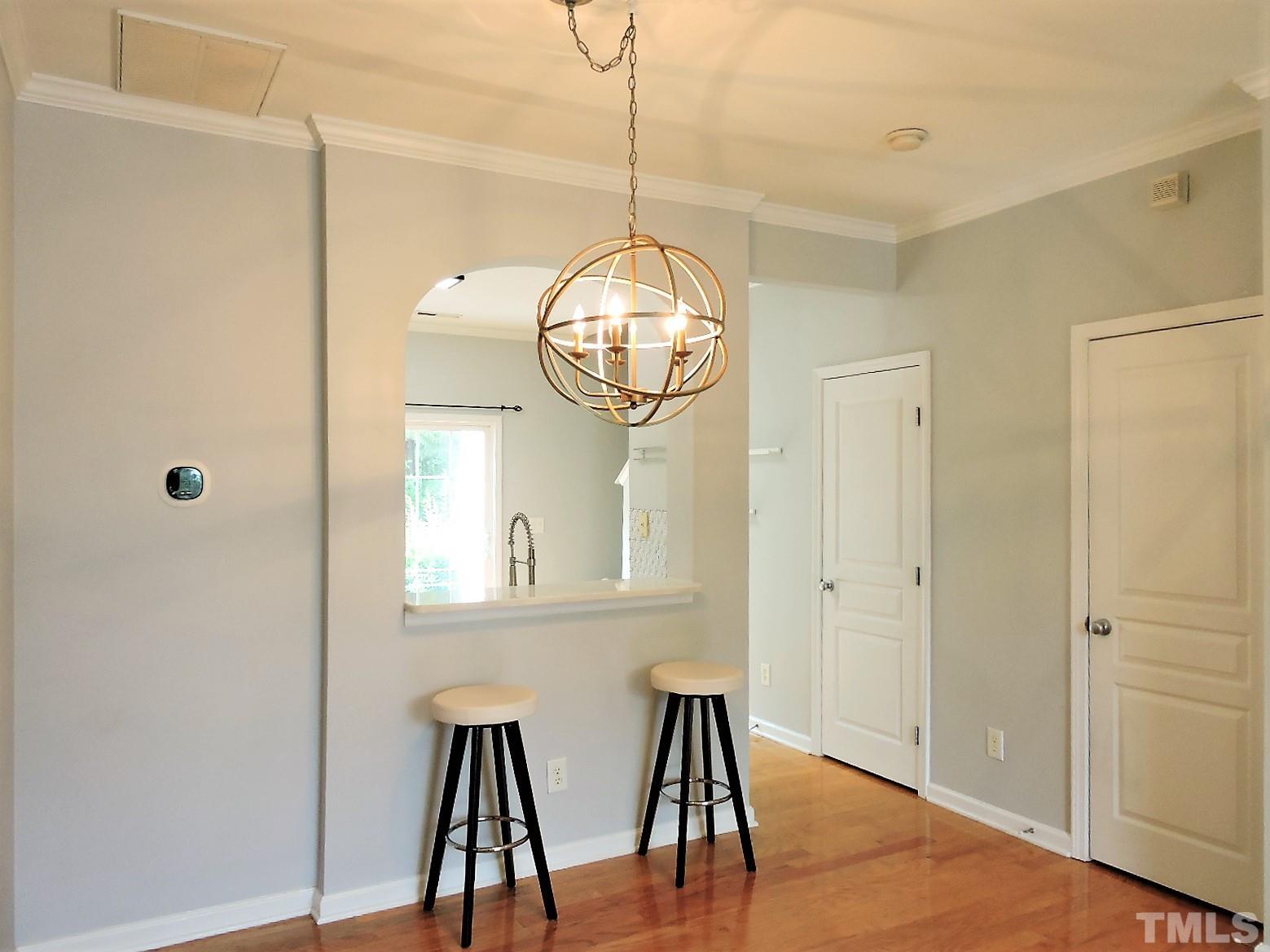 3811 Ramblewood Avenue Durham, NC 27713 - Photo 9 of 29 a view of a hallway with wooden floor and workspace