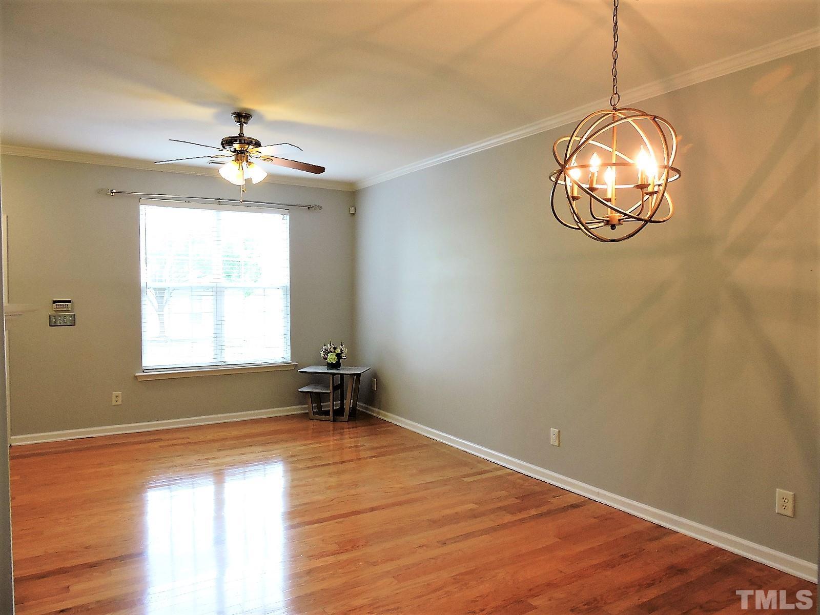 3811 Ramblewood Avenue Durham, NC 27713 - Photo 10 of 29 a view of empty room with window wooden floor and fan