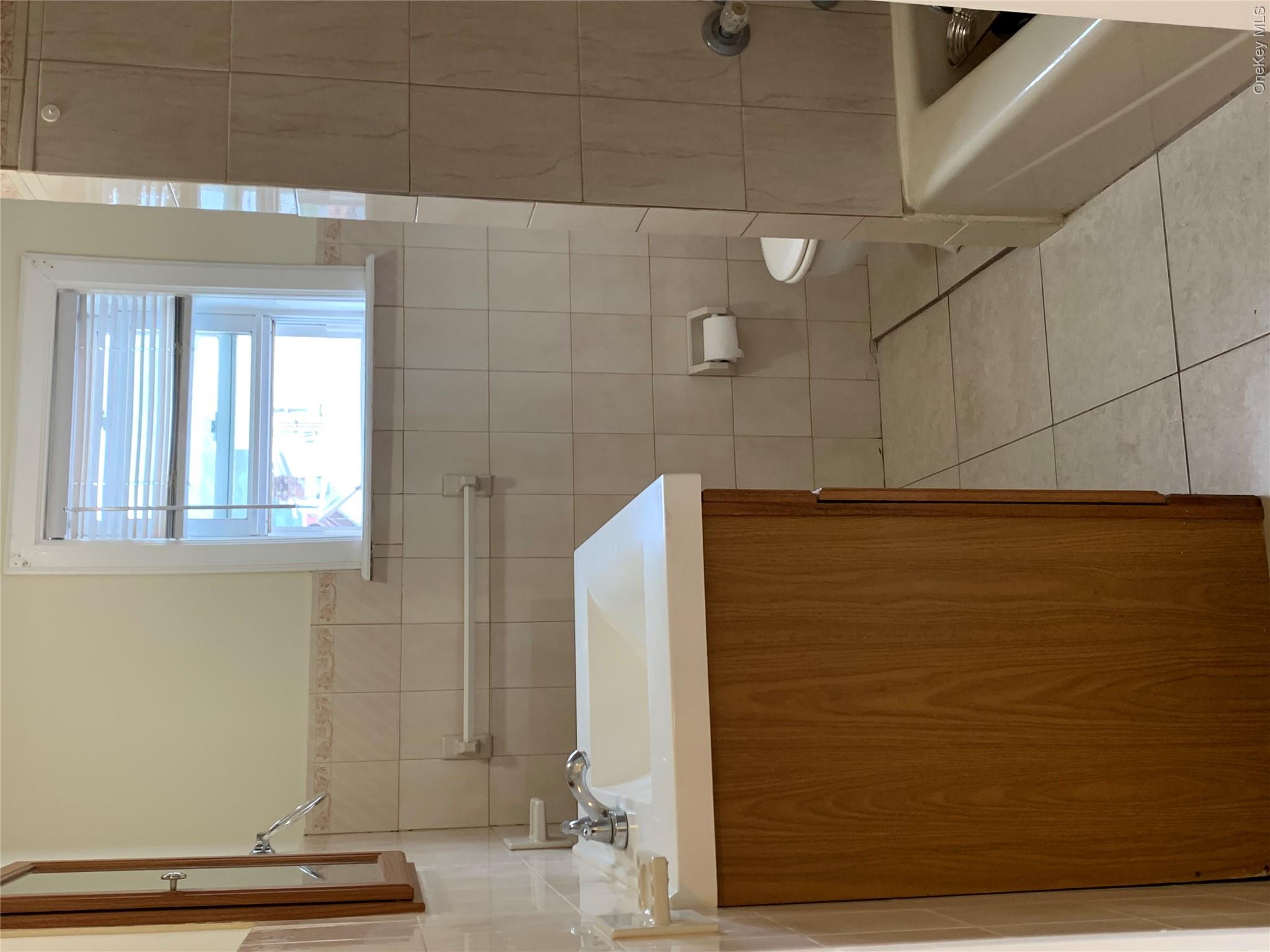 7 Clinton Street Haverstraw, NY 10927 - Photo 9 of 20 Bathroom featuring a vanity with wood-finish cabinetry, a white countertop, and a white basin