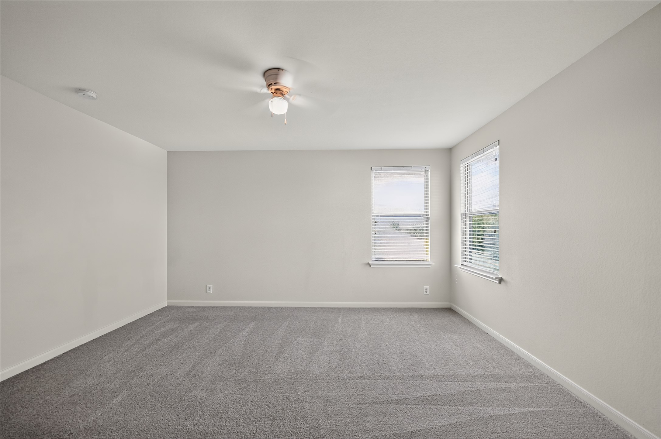 504 Old Peak Road Georgetown, TX 78626 - Photo 19 of 25 A spacious, naturally illuminated room featuring plush carpeting and a ceiling fan for comfort.