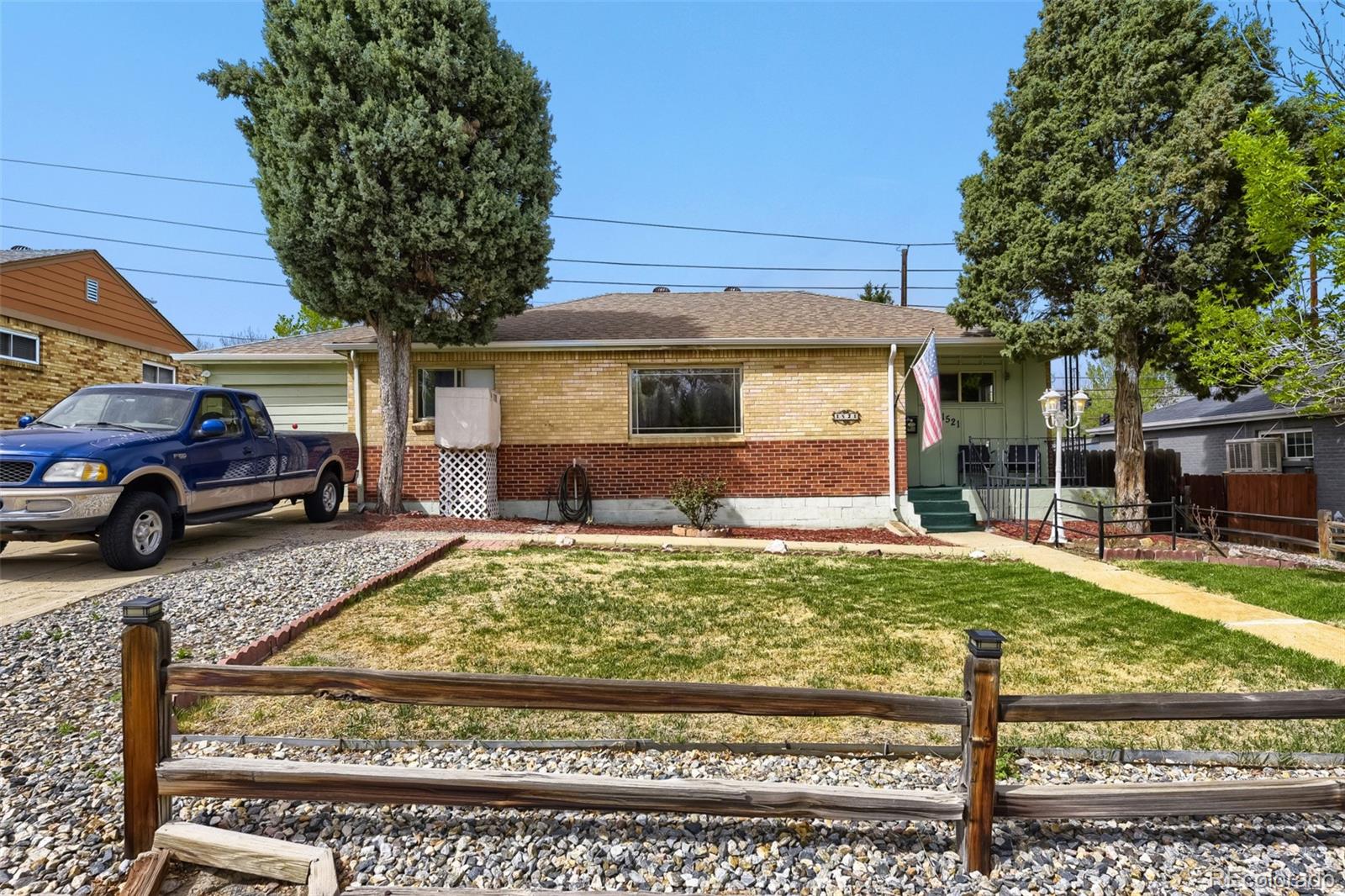1521 Ruth Drive Thornton, CO 80229 - Photo 1 of 23 a front view of a house with garden