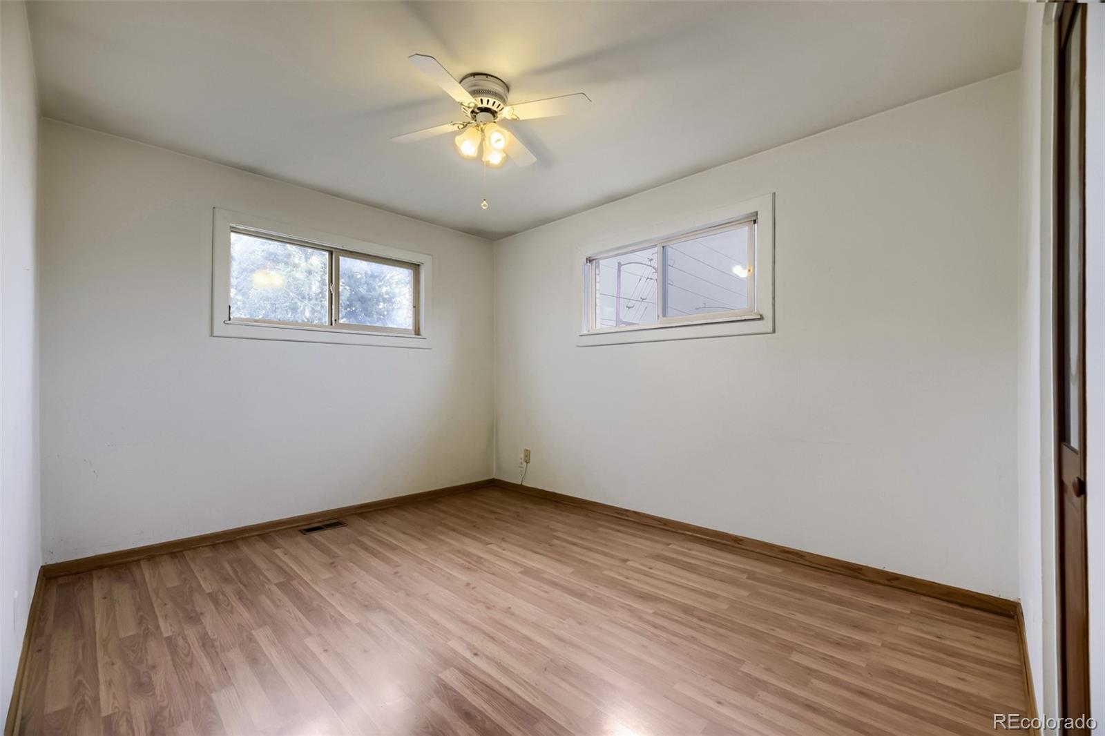 1521 Ruth Drive Thornton, CO 80229 - Photo 14 of 23 a view of an empty room with wooden floor and a window