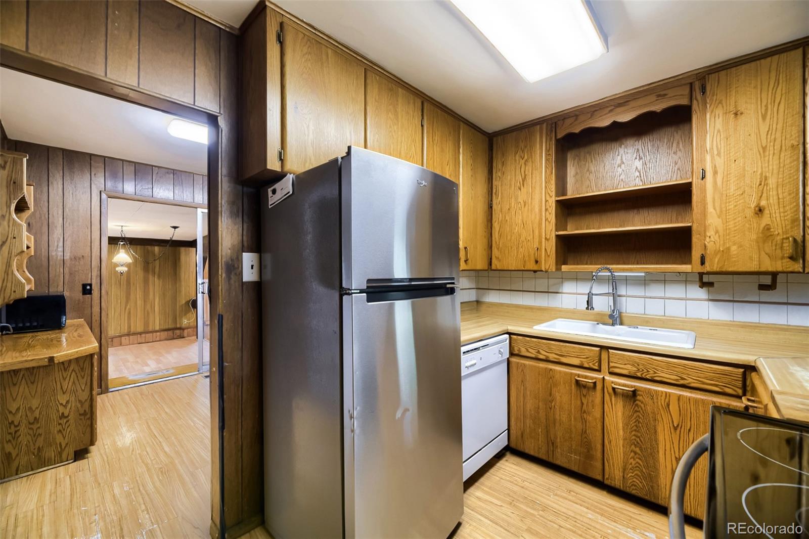 1521 Ruth Drive Thornton, CO 80229 - Photo 6 of 23 a kitchen with stainless steel appliances granite countertop a refrigerator a sink and a stove