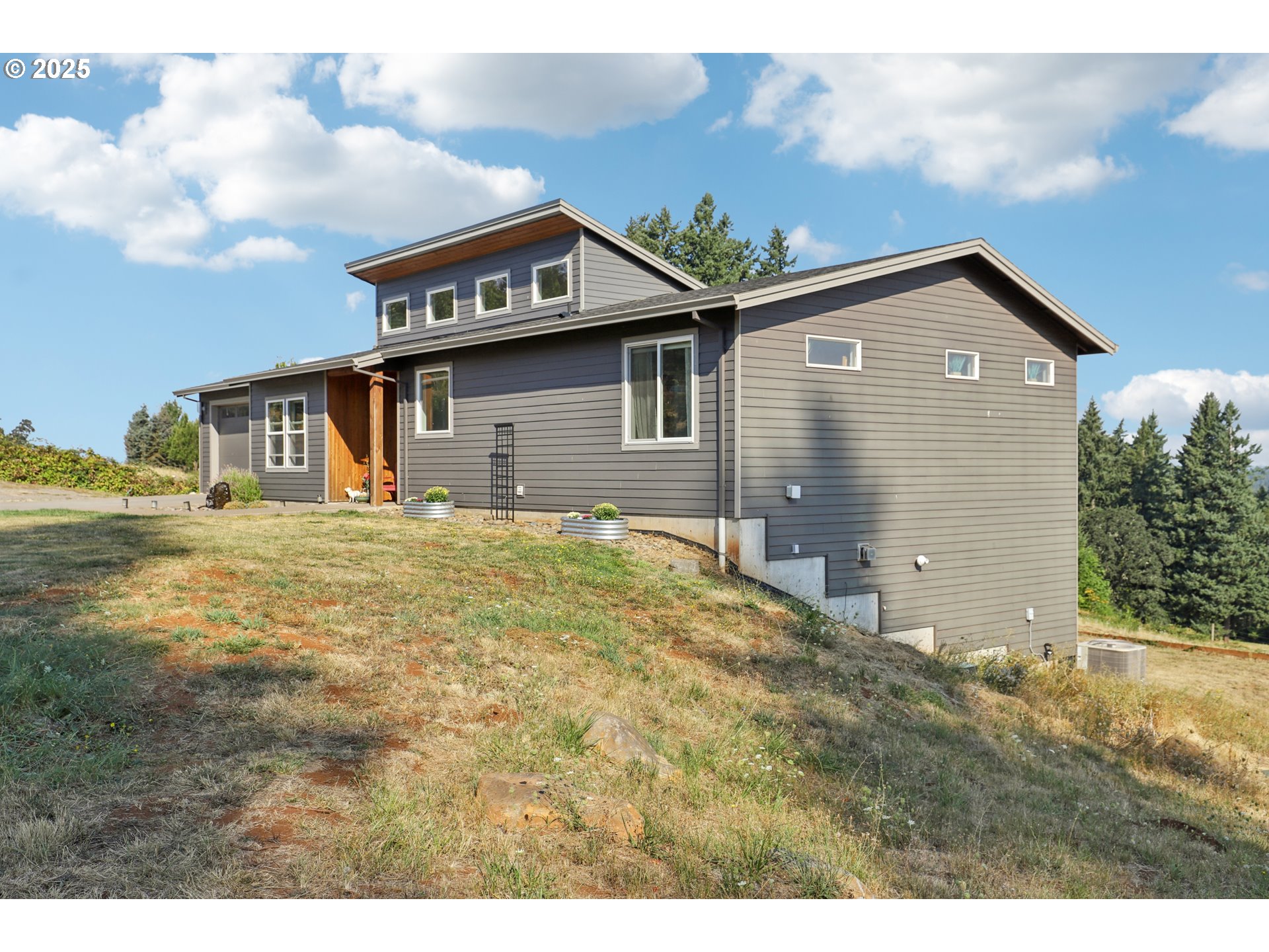 13005 South Casto Road Oregon City, OR 97045 - Photo 3 of 43 a front view of a house with a yard