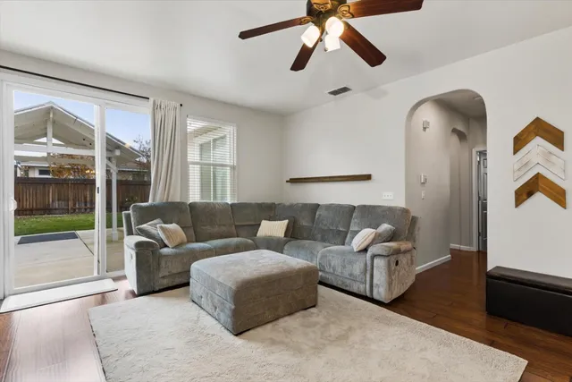 a living room with furniture and a floor to ceiling window