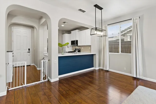 a view of a kitchen with a sink and wooden floor