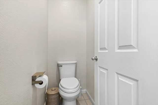 a bathroom with a toilet and a window
