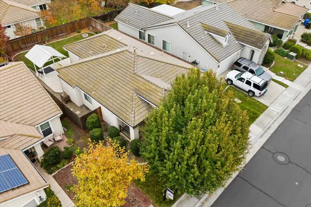an aerial view of a house with a yard
