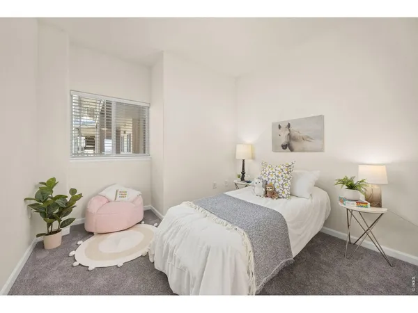a bedroom with a bed and a chair