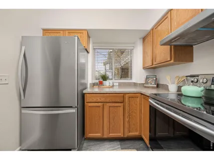 a kitchen with stainless steel appliances a refrigerator sink and cabinets