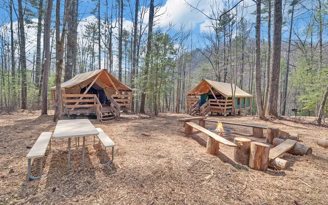 a view of house with a yard and wooden fence