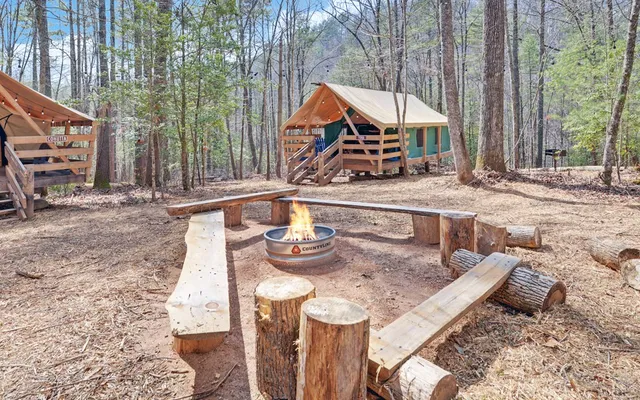 a view of a chairs and table in the backyard