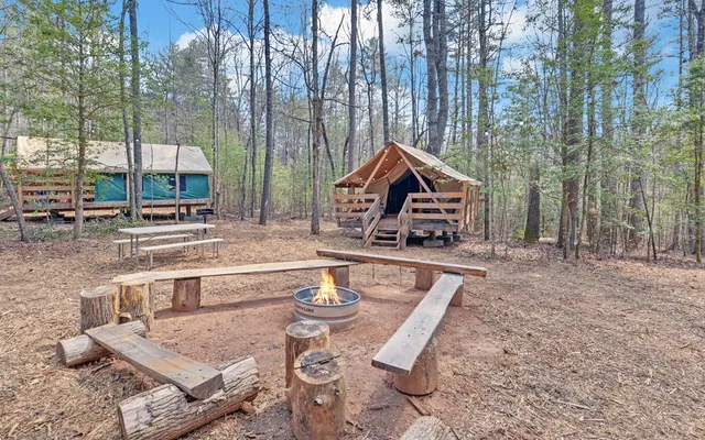a view of a two chairs in the back yard of a house