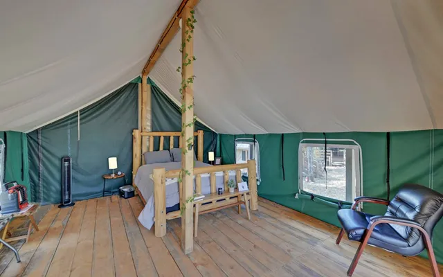 a backyard of a house with barbeque oven table and chairs