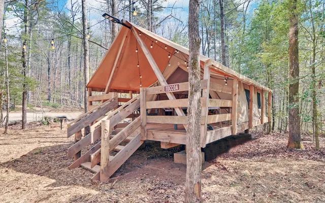 a view of house with a yard and deck