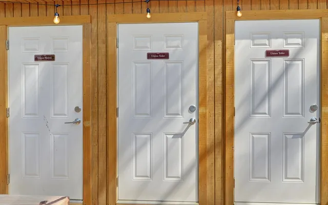 a view of wooden house with a yard and sitting area
